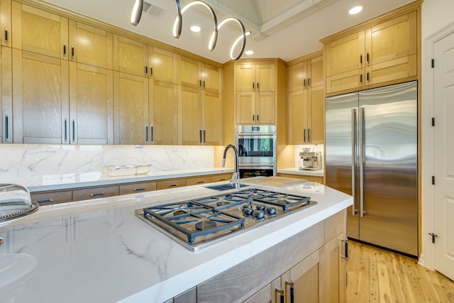 115 Hidden Hills Dr, Spicewood, TX 78669 - kitchen featuring appliances with stainless steel finishes, a sink, backsplash, recessed lighting, and light wood-style flooring