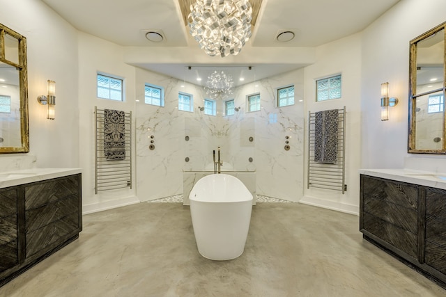 115 Hidden Hills Dr, Spicewood, TX 78669 - bathroom featuring a chandelier, a freestanding bath, finished concrete flooring, and two vanities