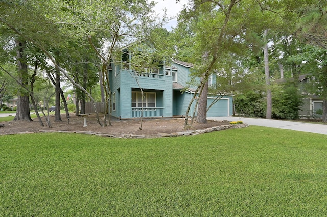 3 Shallow Pond Ct, The Woodlands, TX 77381 - view of front of house with concrete driveway, a front yard, a balcony, and a garage