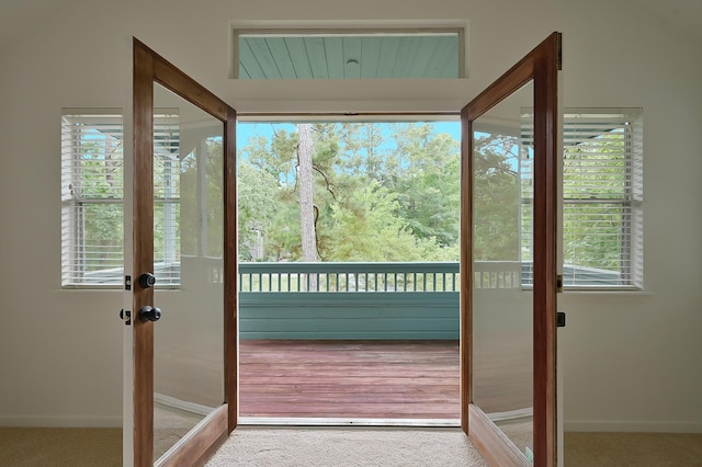 3 Shallow Pond Ct, The Woodlands, TX 77381 - doorway to outside featuring carpet flooring and baseboards