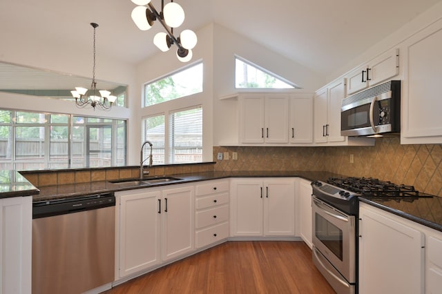 3 Shallow Pond Ct, The Woodlands, TX 77381 - kitchen featuring appliances with stainless steel finishes, a sink, a chandelier, light wood-type flooring, and white cabinetry