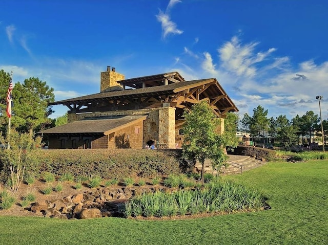 3 Shallow Pond Ct, The Woodlands, TX 77381 - rear view of house with a chimney and a lawn