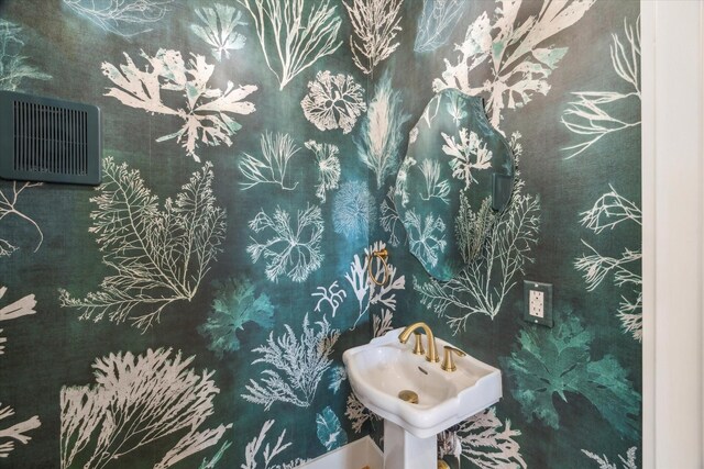 1518 31st St, Galveston, TX 77550 - bathroom featuring a sink and an AC wall unit