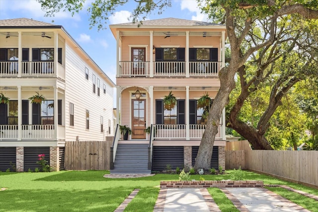 1518 31st St, Galveston, TX 77550 - back of property with a balcony, a porch, stairway, and roof with shingles