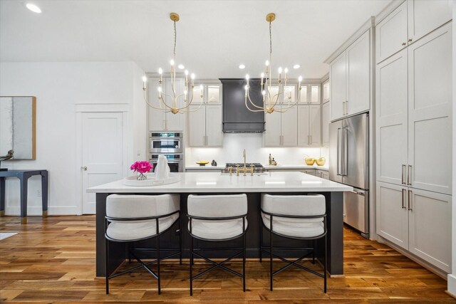 1518 31st St, Galveston, TX 77550 - kitchen with stainless steel appliances, custom range hood, a chandelier, light countertops, and recessed lighting