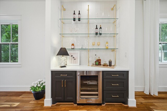 1518 31st St, Galveston, TX 77550 - indoor dry bar featuring wine cooler, healthy amount of natural light, baseboards, and wood finished floors