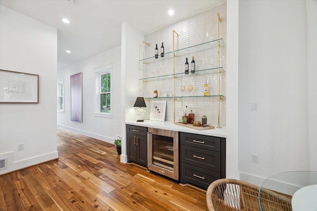1518 31st St, Galveston, TX 77550 - indoor dry bar featuring wine cooler, wood finished floors, baseboards, and recessed lighting