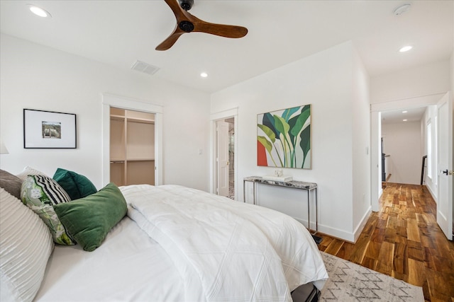 1518 31st St, Galveston, TX 77550 - bedroom with wood finished floors, recessed lighting, a walk in closet, baseboards, and a ceiling fan