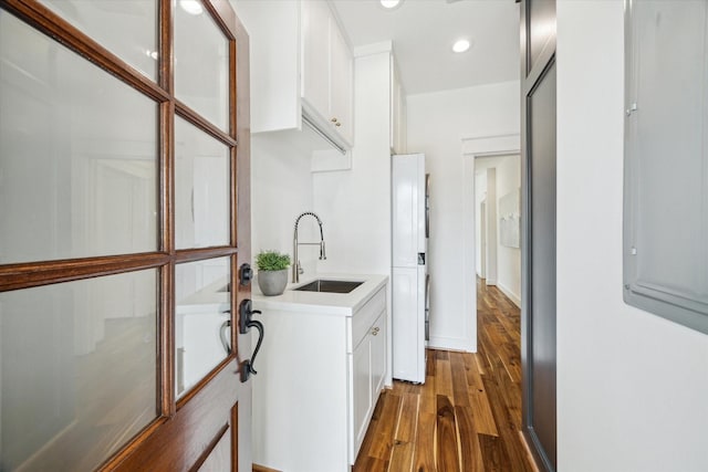 1518 31st St, Galveston, TX 77550 - laundry room with a sink, dark wood-style floors, and recessed lighting