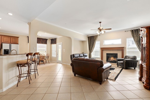 12822 Winding Manor Dr, Houston, TX 77044 - living room with ceiling fan, plenty of natural light, light tile patterned flooring, crown molding, and recessed lighting
