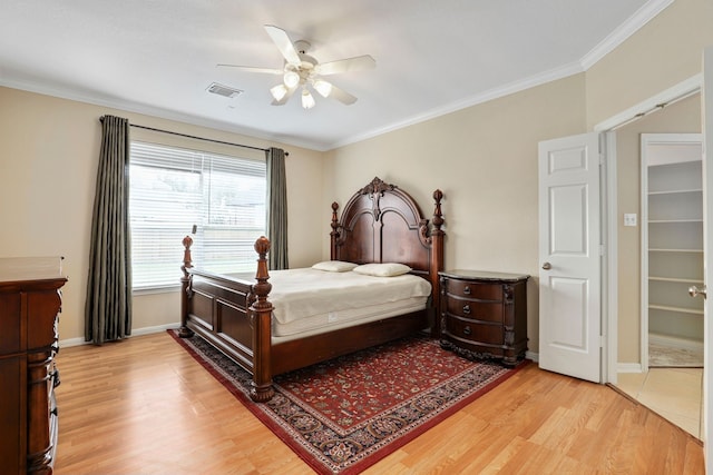 12822 Winding Manor Dr, Houston, TX 77044 - bedroom with light wood-type flooring, baseboards, ceiling fan, and ornamental molding
