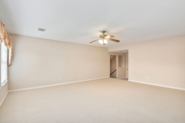 12822 Winding Manor Dr, Houston, TX 77044 - spare room featuring a ceiling fan, light carpet, and baseboards