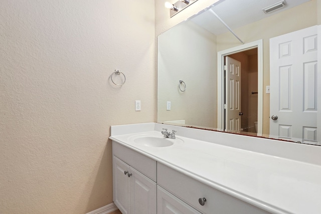 12822 Winding Manor Dr, Houston, TX 77044 - bathroom with vanity, a textured wall, toilet, and baseboards