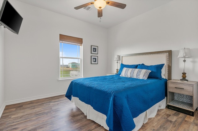 1023 N Bay St, Gilchrist, TX 77617 - bedroom featuring wood finished floors, baseboards, and a ceiling fan