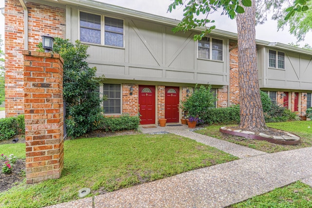 515 Tallowood Rd Unit 1, Houston, TX 77024 - townhome / multi-family property with brick siding and a front yard