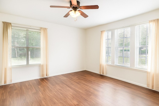 515 Tallowood Rd Unit 1, Houston, TX 77024 - spare room with wood finished floors, plenty of natural light, a ceiling fan, and baseboards