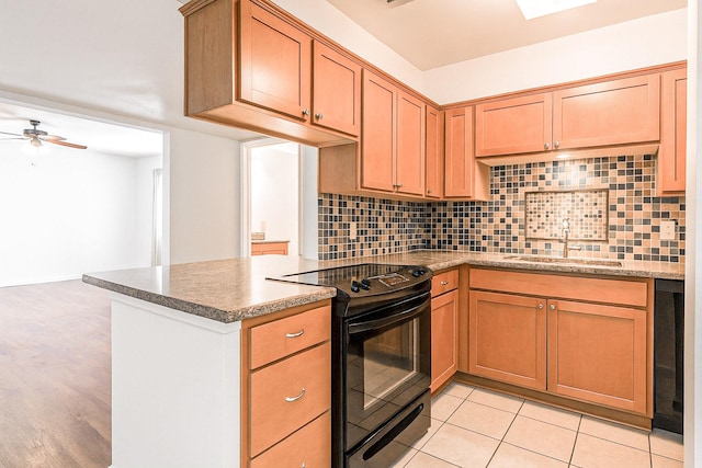 515 Tallowood Rd Unit 1, Houston, TX 77024 - kitchen with black range with electric cooktop, a sink, tasteful backsplash, ceiling fan, and a peninsula