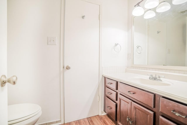 515 Tallowood Rd Unit 1, Houston, TX 77024 - bathroom with vanity, toilet, and wood finished floors