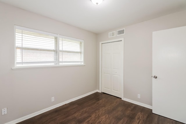 315 Eastlake St, Houston, TX 77034 - unfurnished bedroom with dark wood-style flooring, baseboards, and a closet