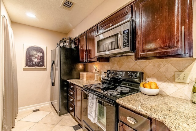 5200 Weslayan St Unit 108, Houston, TX 77005 - kitchen featuring appliances with stainless steel finishes, a textured ceiling, decorative backsplash, baseboards, and light stone counters