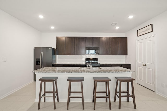12022 Fletching Stone Ln, Houston, TX 77044 - kitchen featuring black microwave, gas range, decorative backsplash, a breakfast bar, and a sink