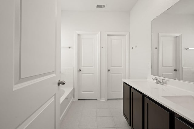 12022 Fletching Stone Ln, Houston, TX 77044 - bathroom featuring tile patterned floors, double vanity, and a bath