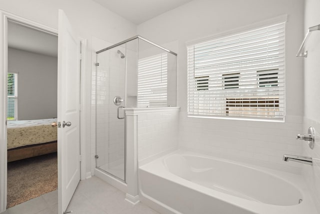 12022 Fletching Stone Ln, Houston, TX 77044 - bathroom featuring a garden tub, ensuite bathroom, a stall shower, and tile patterned flooring