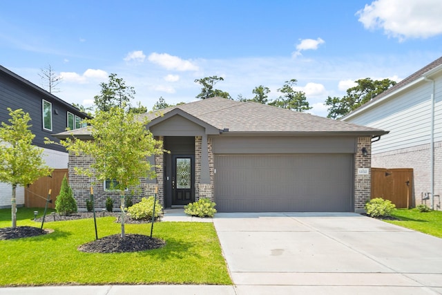 12022 Fletching Stone Ln, Houston, TX 77044 - view of front of property featuring brick siding, an attached garage, driveway, and roof with shingles
