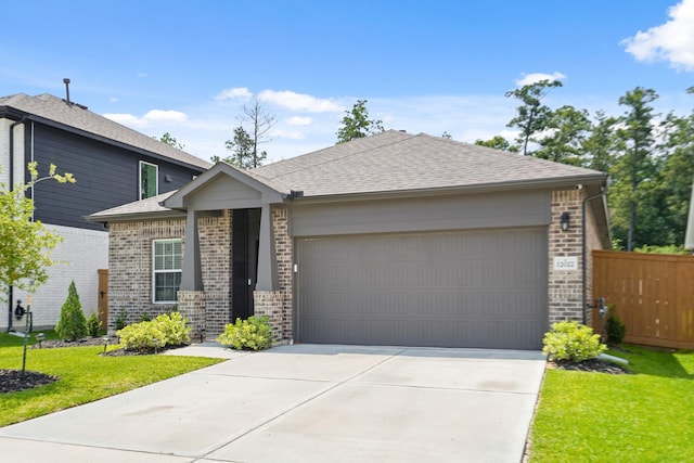 12022 Fletching Stone Ln, Houston, TX 77044 - view of front of house featuring brick siding, an attached garage, concrete driveway, and roof with shingles