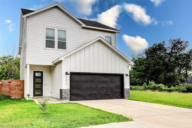7810 Kenton St, Houston, TX 77028 - view of front of house with board and batten siding, stone siding, and concrete driveway