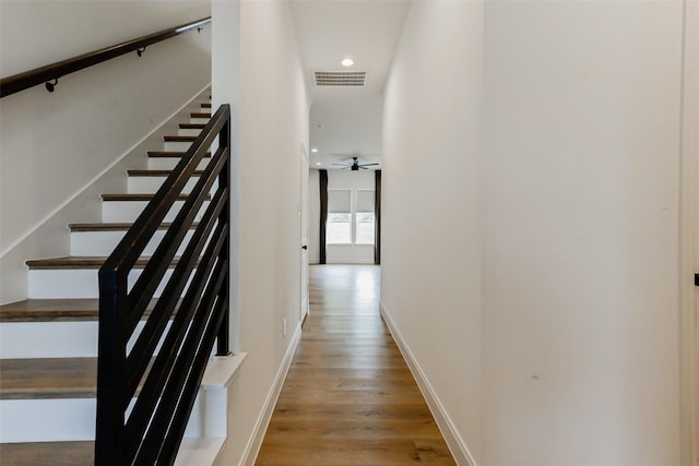 7810 Kenton St, Houston, TX 77028 - stairs featuring wood finished floors, recessed lighting, baseboards, and a ceiling fan