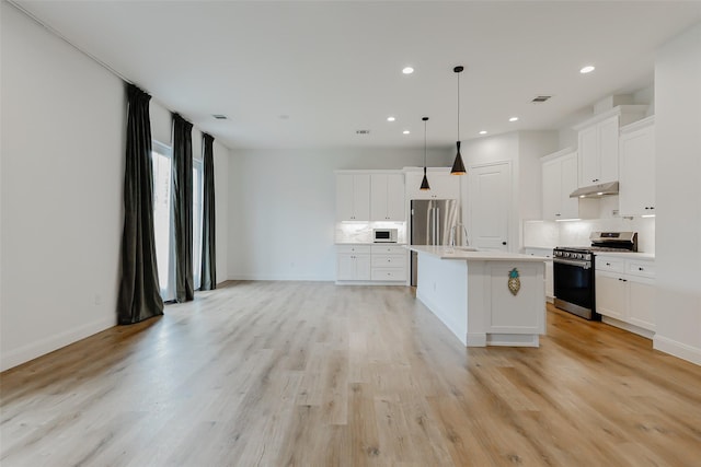7810 Kenton St, Houston, TX 77028 - kitchen featuring stainless steel appliances, under cabinet range hood, backsplash, light countertops, and recessed lighting