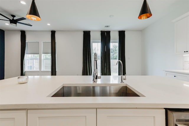 7810 Kenton St, Houston, TX 77028 - kitchen with a sink, light countertops, recessed lighting, white cabinets, and a ceiling fan