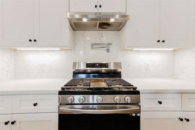 7810 Kenton St, Houston, TX 77028 - kitchen featuring stainless steel gas range, under cabinet range hood, light countertops, and white cabinets