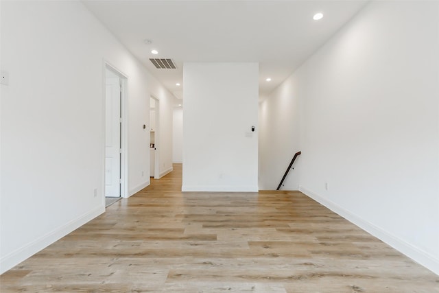 7810 Kenton St, Houston, TX 77028 - hallway with an upstairs landing, recessed lighting, light wood-style floors, and baseboards