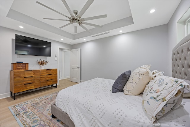 18215 Hereford Ln, Houston, TX 77058 - bedroom featuring recessed lighting, a raised ceiling, light wood-style flooring, baseboards, and a ceiling fan