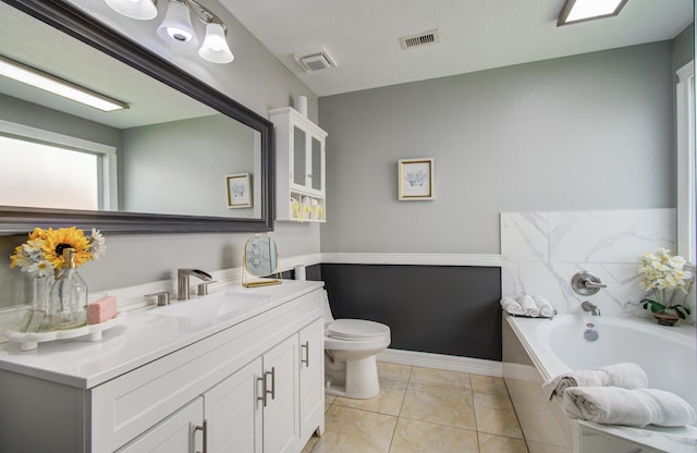20507 Hillsdale Park Dr, Cypress, TX 77433 - bathroom with toilet, vanity, a garden tub, and baseboards