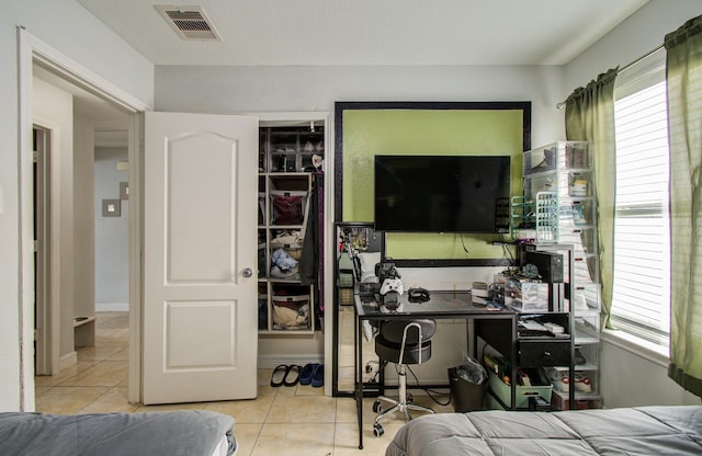20507 Hillsdale Park Dr, Cypress, TX 77433 - bedroom with tile patterned floors, multiple windows, and a desk