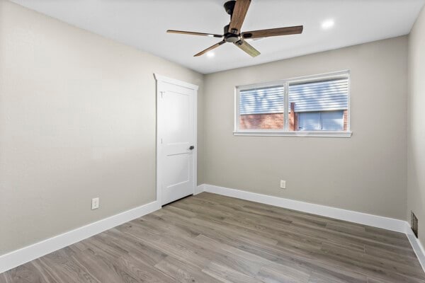 10719 Carlota Ct, Houston, TX 77096 - unfurnished room featuring baseboards, wood finished floors, ceiling fan, and recessed lighting