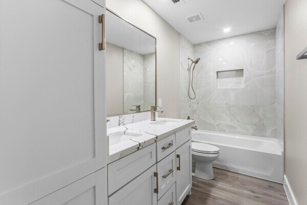 10719 Carlota Ct, Houston, TX 77096 - full bath with toilet, wood finished floors, double vanity, and  shower combination