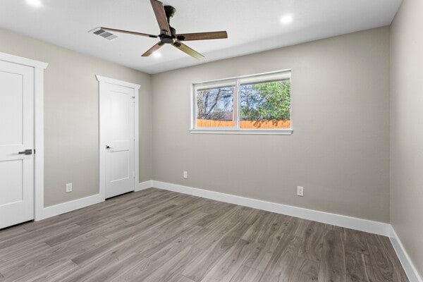 10719 Carlota Ct, Houston, TX 77096 - unfurnished bedroom featuring light wood-style floors, baseboards, recessed lighting, and ceiling fan