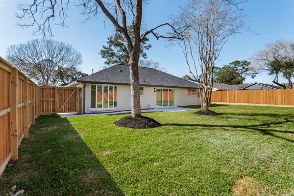 10719 Carlota Ct, Houston, TX 77096 - back of property with a fenced backyard and a patio