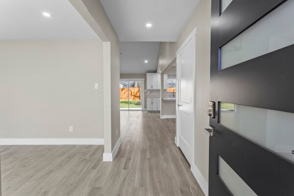 10719 Carlota Ct, Houston, TX 77096 - entrance foyer featuring light wood-style flooring, baseboards, and recessed lighting