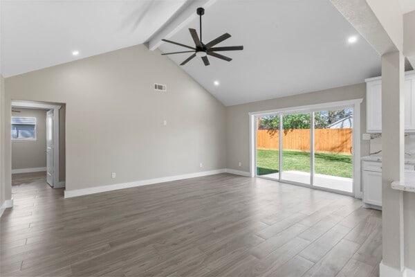 10719 Carlota Ct, Houston, TX 77096 - unfurnished living room with ceiling fan, beamed ceiling, baseboards, wood finished floors, and high vaulted ceiling