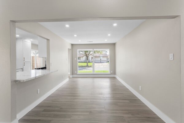 10719 Carlota Ct, Houston, TX 77096 - empty room with wood finished floors, baseboards, and recessed lighting