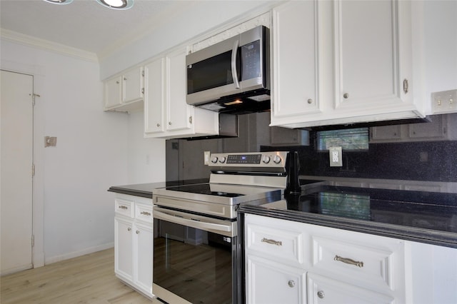 15803 Pryor Dr, Houston, TX 77489 - kitchen featuring stainless steel appliances, ornamental molding, white cabinetry, and light wood-style flooring