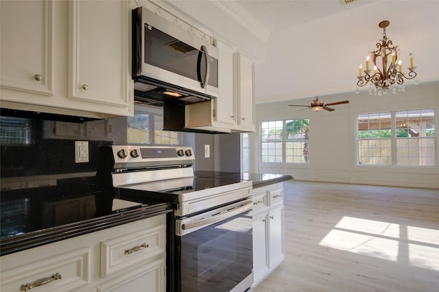 15803 Pryor Dr, Houston, TX 77489 - kitchen featuring stainless steel appliances, a ceiling fan, a chandelier, light wood-style flooring, and dark countertops