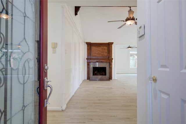 15803 Pryor Dr, Houston, TX 77489 - foyer entrance featuring ceiling fan, light wood-type flooring, a high end fireplace, and baseboards