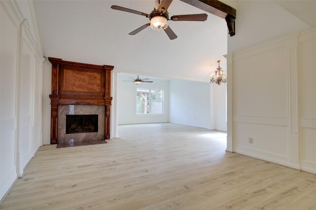 15803 Pryor Dr, Houston, TX 77489 - unfurnished living room featuring ceiling fan, a high end fireplace, light wood finished floors, high vaulted ceiling, and a decorative wall