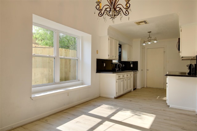 15803 Pryor Dr, Houston, TX 77489 - kitchen featuring a chandelier, white cabinetry, light wood-type flooring, and crown molding